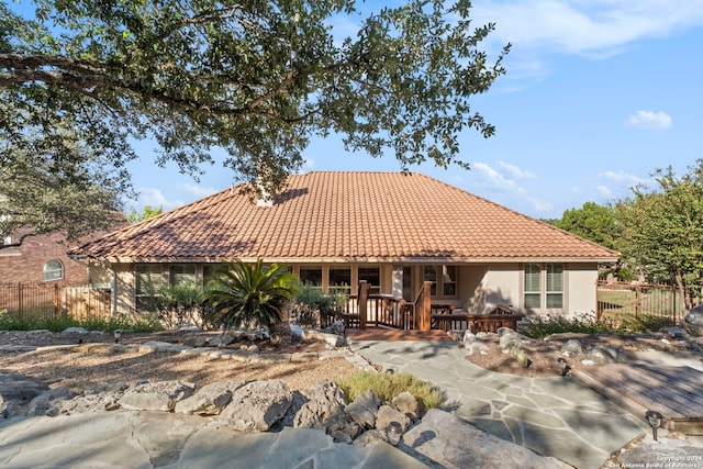 back of property featuring a wooden deck