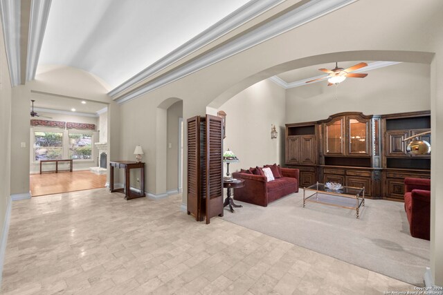 living room featuring light carpet, lofted ceiling, ceiling fan, and crown molding