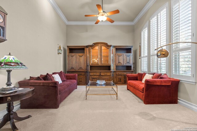 carpeted living room featuring ornamental molding and ceiling fan