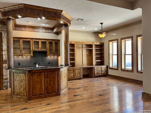 kitchen with ceiling fan, backsplash, hardwood / wood-style flooring, and ornamental molding