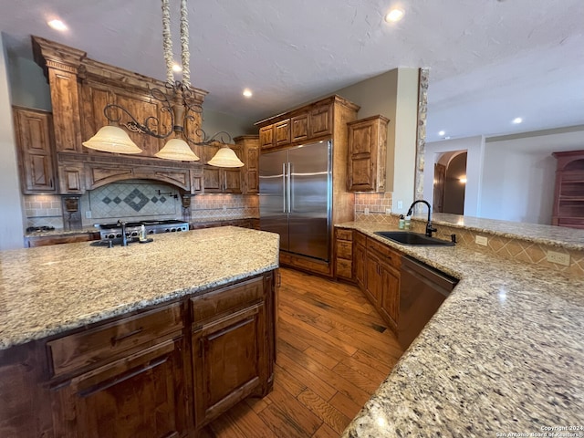 kitchen featuring sink, stainless steel appliances, decorative backsplash, and dark hardwood / wood-style flooring