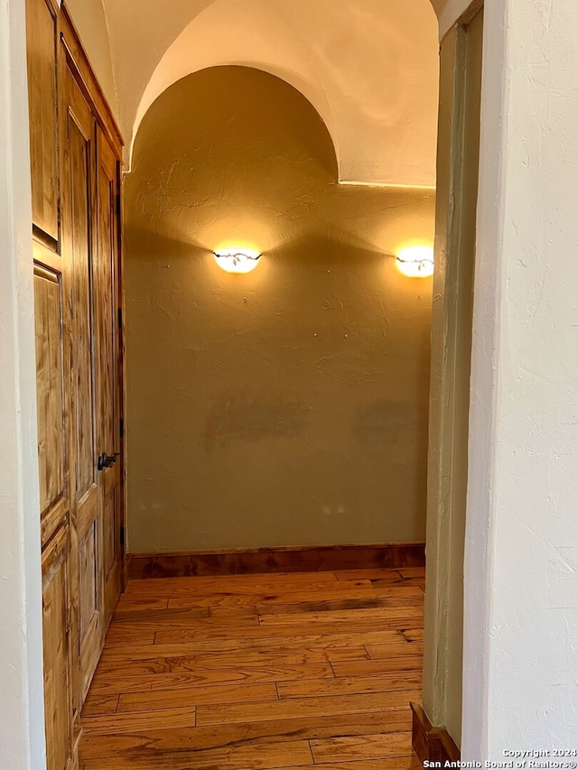 hallway with hardwood / wood-style floors