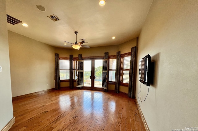 empty room with ceiling fan and hardwood / wood-style flooring