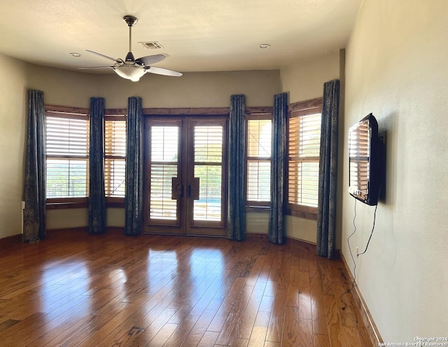 empty room featuring hardwood / wood-style flooring, french doors, and ceiling fan