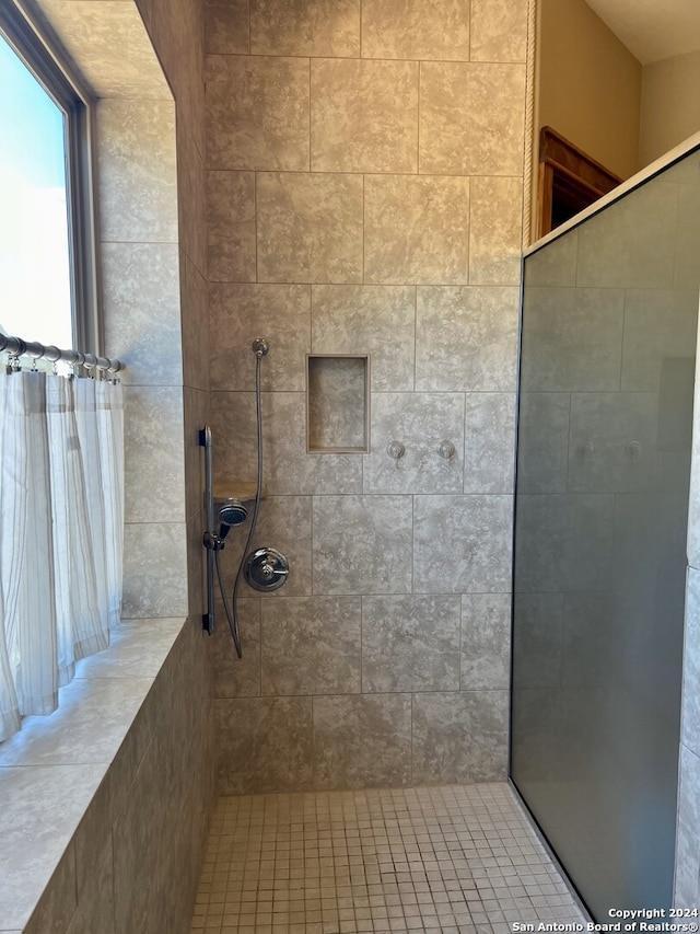 bathroom with a tile shower