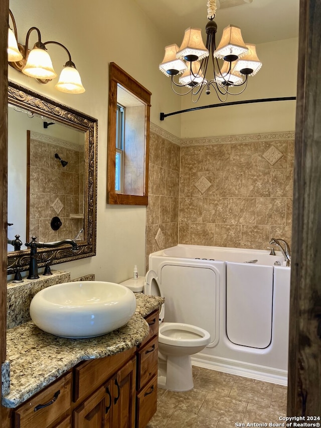 bathroom with tile patterned flooring, vanity, a chandelier, and toilet