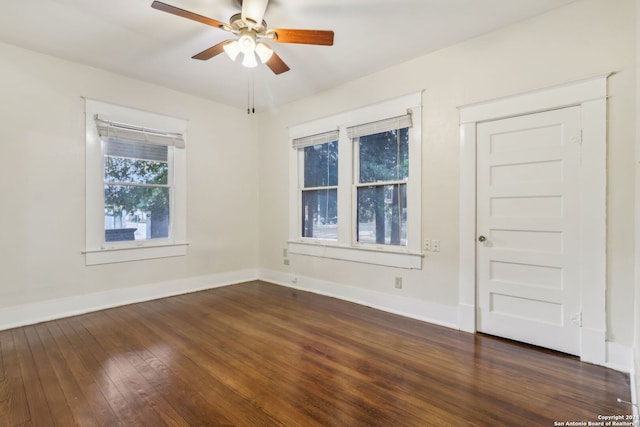 unfurnished room with ceiling fan and dark hardwood / wood-style flooring