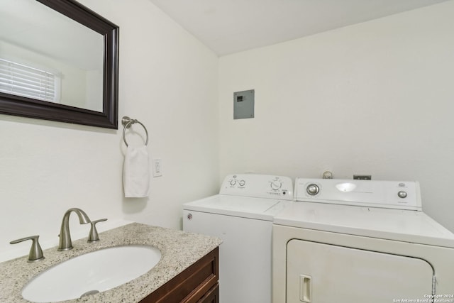 washroom with separate washer and dryer and sink