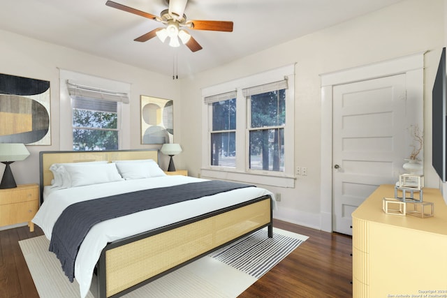 bedroom featuring ceiling fan and dark wood-type flooring