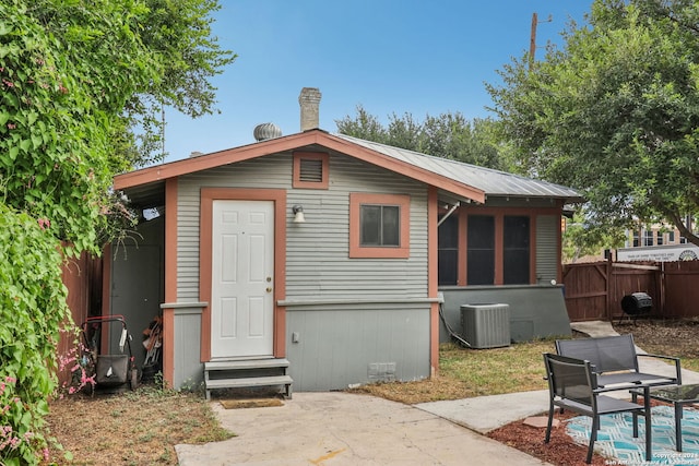 back of house featuring cooling unit and a patio area