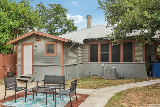 back of house with central air condition unit and a patio