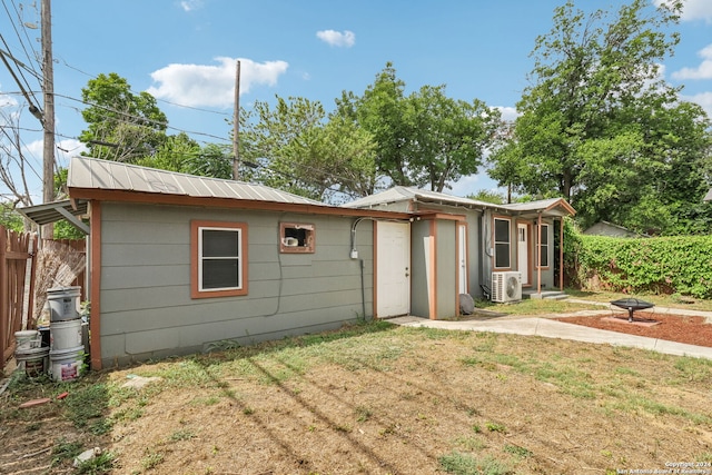 back of property with a lawn