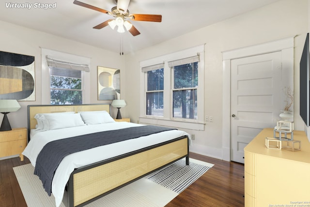 bedroom with ceiling fan and dark wood-type flooring