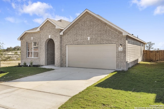 view of front of home featuring a front lawn and a garage