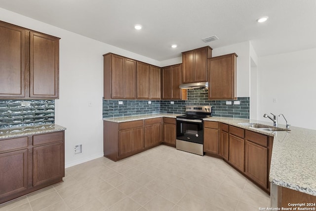 kitchen with sink, stainless steel electric range, tasteful backsplash, and light stone countertops