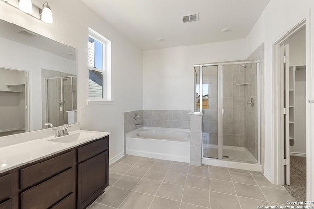 bathroom with tile patterned flooring, vanity, and independent shower and bath