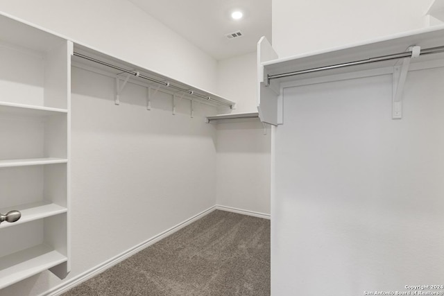 spacious closet featuring dark carpet