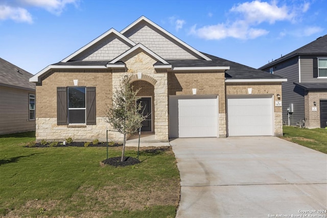 craftsman-style house with a garage and a front lawn