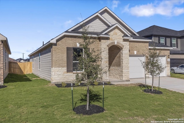 view of front of house with a garage and a front lawn