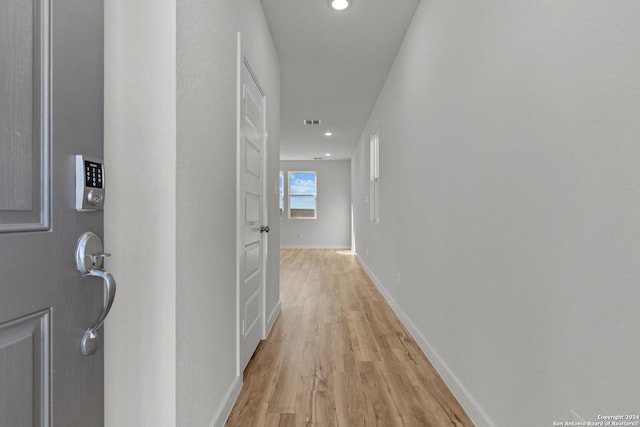 hallway featuring recessed lighting, visible vents, light wood finished floors, and baseboards