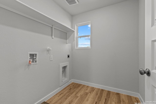 laundry room featuring hookup for an electric dryer, hookup for a washing machine, light hardwood / wood-style flooring, and gas dryer hookup