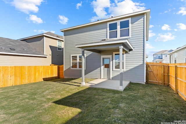 back of property with a patio and a lawn