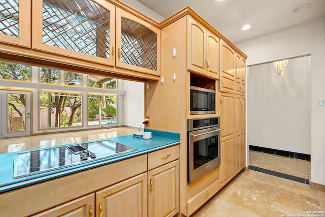 kitchen featuring stainless steel appliances, dark countertops, recessed lighting, light brown cabinetry, and glass insert cabinets