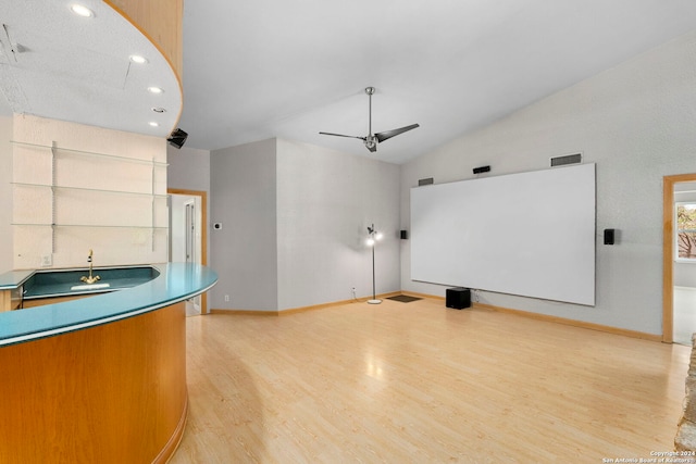 kitchen with dark countertops, light wood-style flooring, ceiling fan, modern cabinets, and baseboards