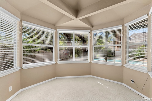 unfurnished sunroom featuring lofted ceiling and plenty of natural light