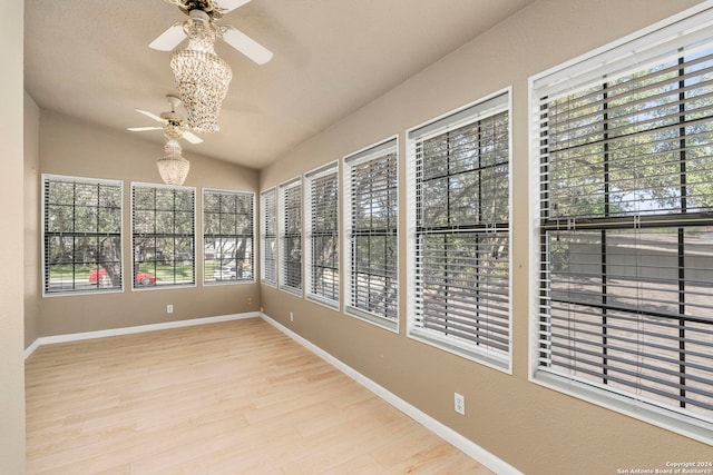 unfurnished sunroom with vaulted ceiling and ceiling fan