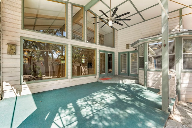 unfurnished sunroom featuring ceiling fan