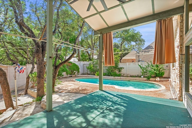 view of swimming pool featuring a fenced backyard, a fenced in pool, and a patio