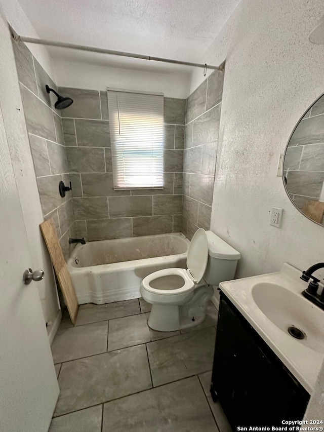 full bathroom with toilet, vanity, tile patterned floors, a textured ceiling, and tiled shower / bath combo