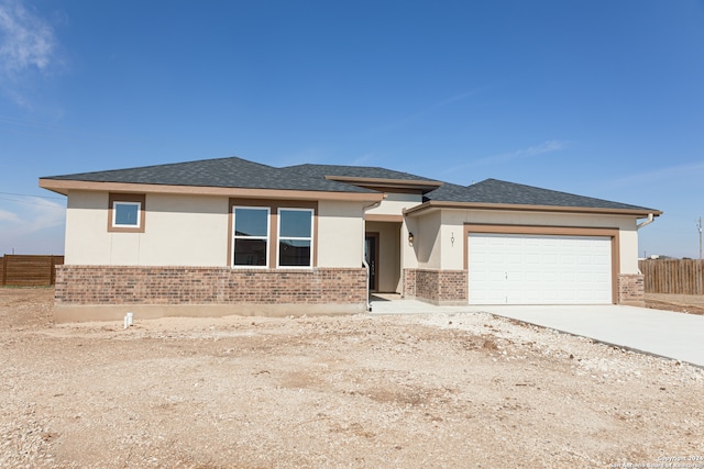 prairie-style home featuring a garage