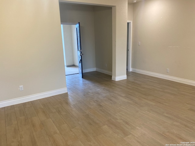 unfurnished room with hardwood / wood-style flooring