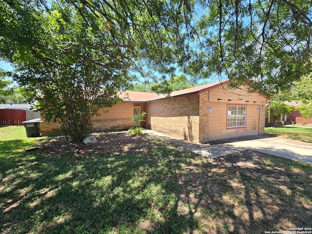 ranch-style house with a patio and a front yard