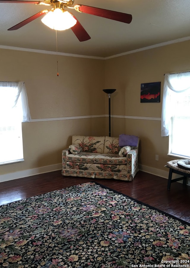 living room featuring ceiling fan, hardwood / wood-style flooring, and crown molding