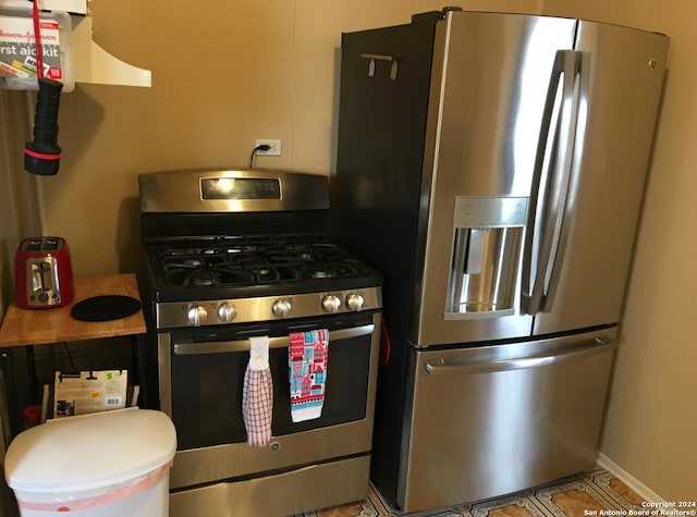 kitchen featuring stainless steel appliances and light tile patterned floors