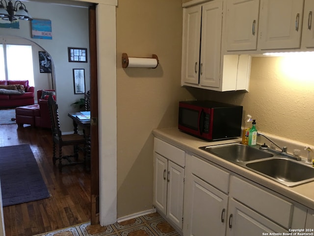 kitchen with white cabinetry, dark hardwood / wood-style floors, and sink