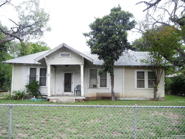 bungalow-style home with a front lawn