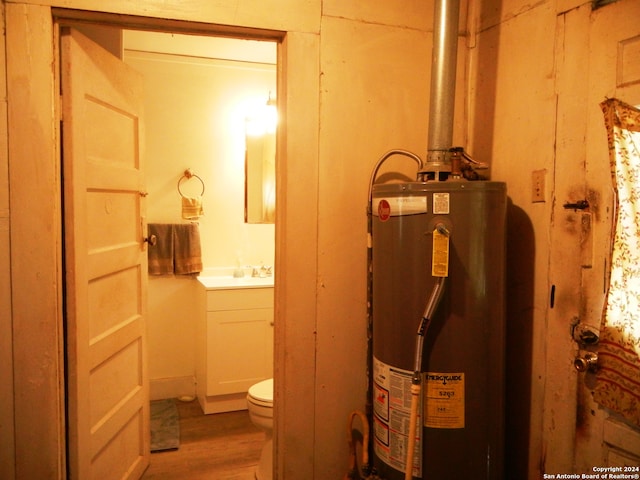 utility room with sink and gas water heater