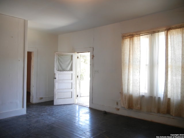 unfurnished room featuring plenty of natural light and tile patterned flooring