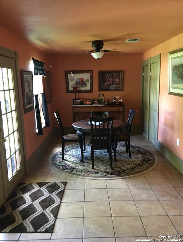 tiled dining room with ceiling fan