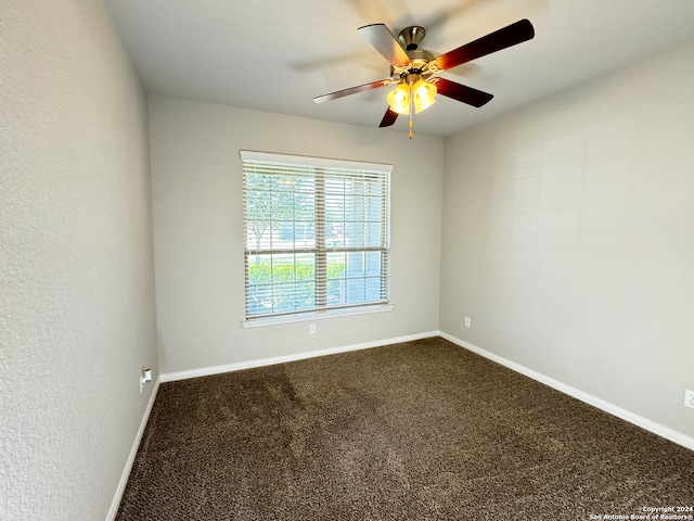 spare room with ceiling fan and carpet