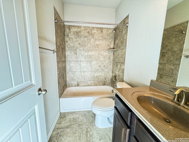 full bathroom featuring tiled shower / bath, toilet, tile patterned flooring, and vanity