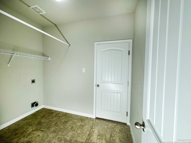 laundry area featuring tile patterned flooring and electric dryer hookup