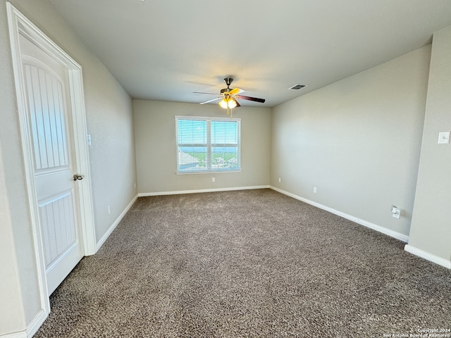 empty room featuring carpet and ceiling fan