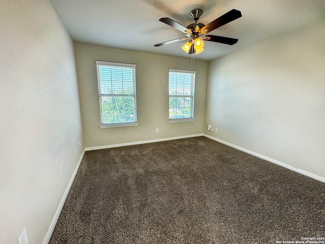 unfurnished room with ceiling fan and carpet