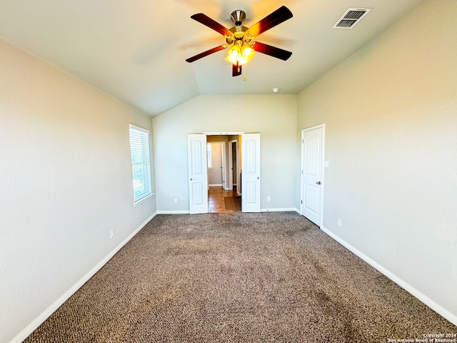 unfurnished bedroom featuring carpet floors, vaulted ceiling, and ceiling fan