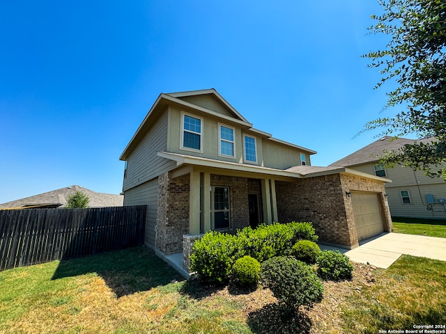 view of front of property featuring a garage and a front lawn